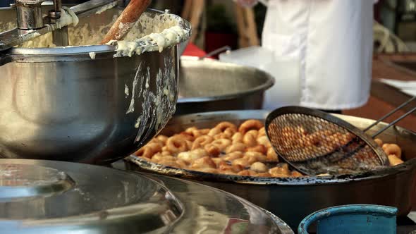 Street Vendor Cooks And Sells Hot Oil Dough 3 alt