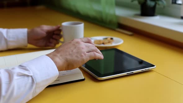 Businessman is Working and Drinking Tea in the Office alt