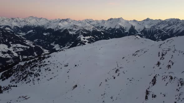 Snowy Mountain Skilifts and Furniculars and Skislopes in Austrian Alps Drone Flyover the Mountains