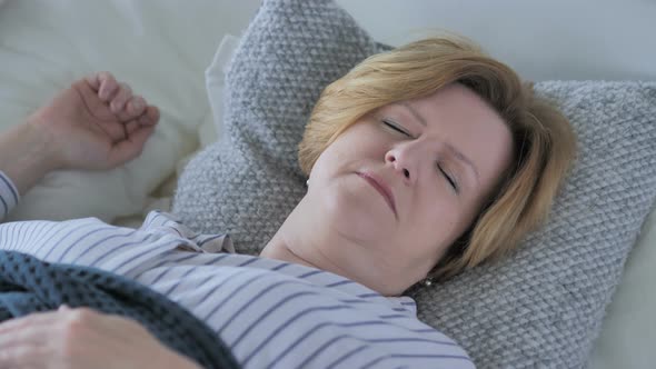 Uncomfortable Old Senior Woman Sleeping in Bed alt