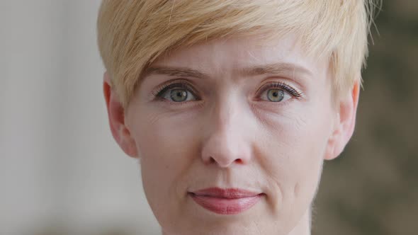 Portrait of Mature Adult Woman with Short Hair Looking at Camera with Serious Expression alt
