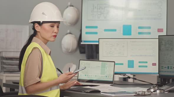 Portrait of Female Asian Engineer in Hart Hat at Office Desk, Stock Footage