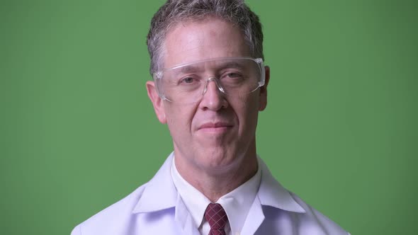 Portrait of Happy Mature Man Doctor with Protective Glasses