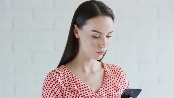 Cheerful Woman Using Smartphone alt