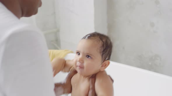 Indian Father Bonding with Toddler Girl during Bath Time alt