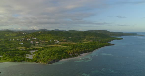 Aerial of beautiful green landscape along sea, Cap Chevalier, Sainte-Anne alt
