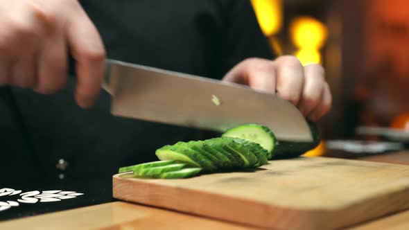 Slicing of a Cucumber in the Restaurant Kitchen