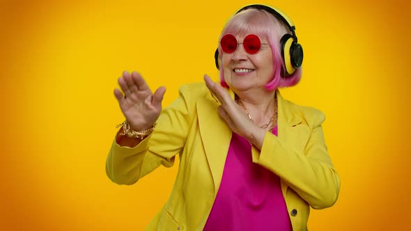 Senior Woman Listening Music on Headphones Dancing Disco Fooling Having Fun Gesticulating Hands alt