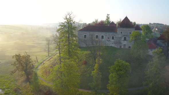 Aerial View of Svirzh Castle Near Lviv, Ukraine at Dawn. Lake, Morning Fog and Surrounding Landscape alt