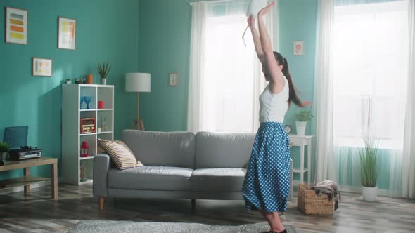 Young Housekeeper Is Dancing with Cleaning Brush at Home