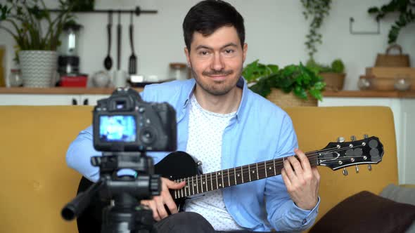 Blogger Shoots Video Playing Electric Guitar at Home