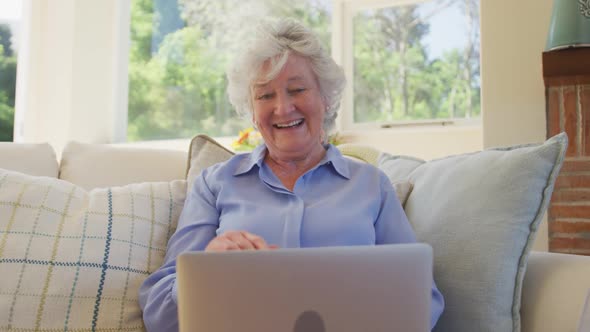 Senior caucasian woman using laptop computer for video chat alt