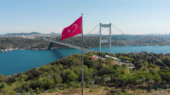 Aerial view of Fatih Sultan Mehmet Bridge and Turkish Flag alt
