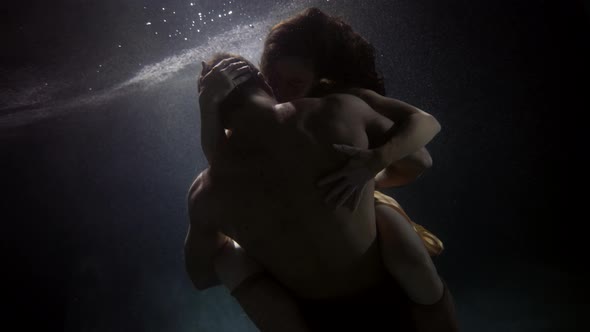 Young Man and Woman Are Having Sex Underwater Medium Shot of Muscular Naked Male Back Slow Motion alt