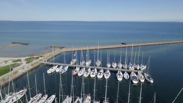 Drone Flies Past Sail Boats And Out On The Seas