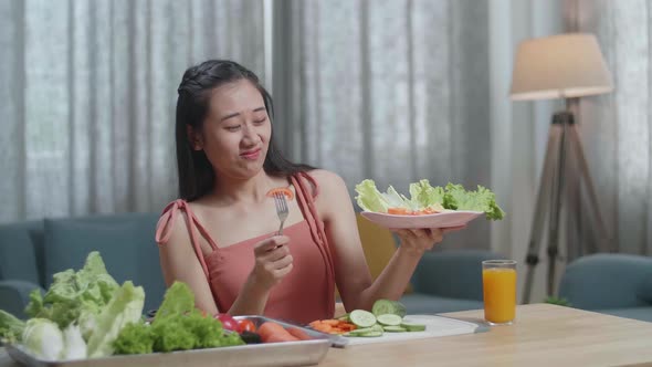 Asian Woman Shaking Her Head Due To Hating Eating Healthy Food While Having A Meal At Home alt