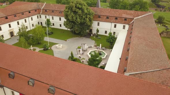 Aerial Close up of Monastery / Citadel Roof with Garden and trees in the courtyard, showing the slat alt