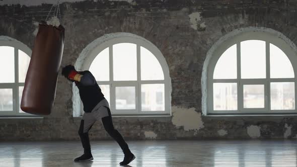 Full Length of a Boxer Training at Boxing Studio in Gloves alt