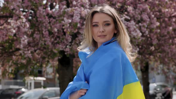 Portrait of Beautiful Ukrainian Woman with Flag on Her Shoulders