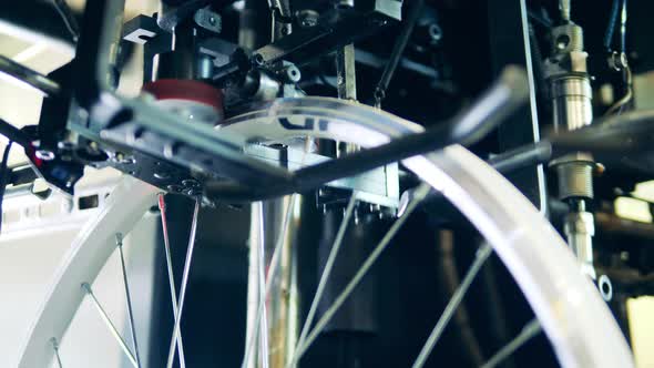 Modern Machine Truing a Bicycle Rim at a Factory alt