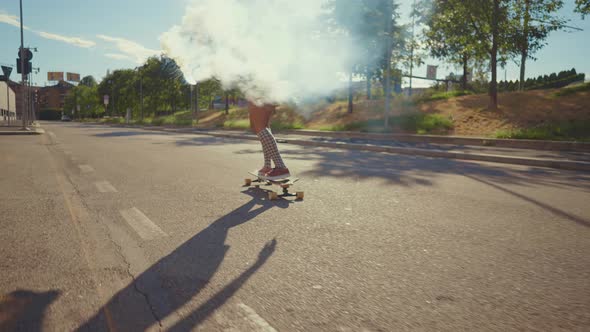 Beautiful young woman cruising around the city with her longboard. alt