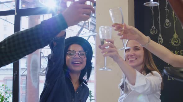 Multiethnic Team of Designers Toasting with Champagne at Office Party