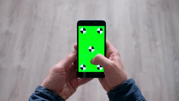 Hands of Man Slowly Scroll Up Information on Smartphone  with Green Screen alt