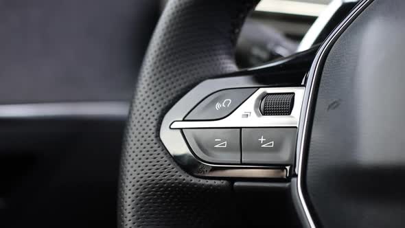 Volume Buttons on the Multifunctional Steering Wheel of a Modern Car