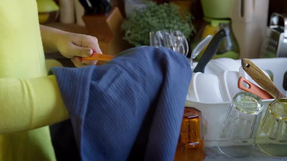 Housewife Wipes Clean Kitchen Appliances After Washing Dishes with a Dry Towel. alt