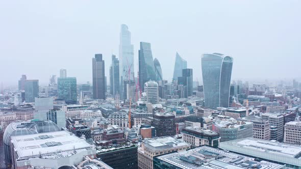 London snow aerial city centre skyscrapers beautiful rotating drone shot alt