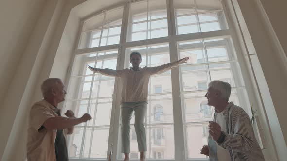 Mature Woman Dancing on Window Sill with Friends alt