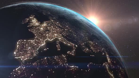 Sun rises above the horizon of the Earth against the background of stars and galaxies. alt