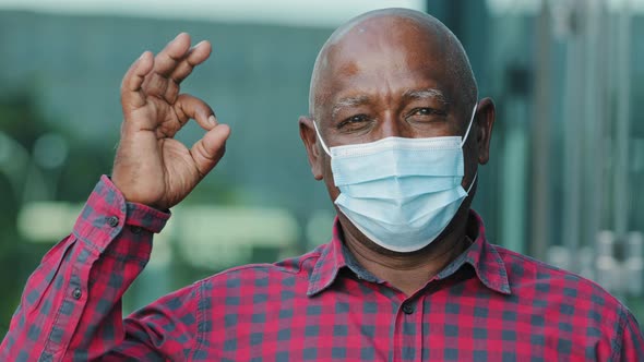 Closeup Portrait Elderly African American Man in Facemask Protect From Coronavirus Shows Ok Gesture alt