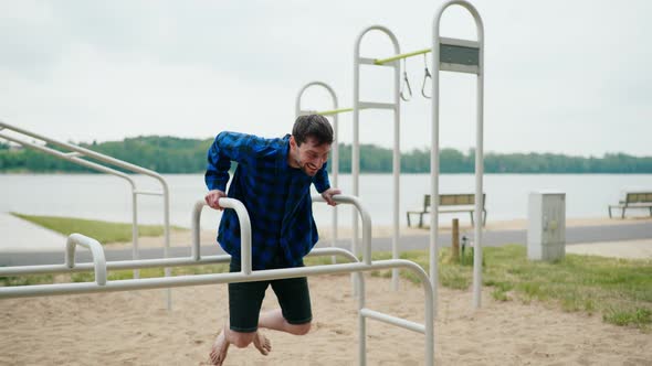 Young Strong Man Exercising on the Beach alt
