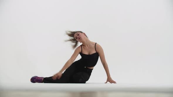 Dancing  Young Stylish Woman Dancing on the Floor on White Background alt