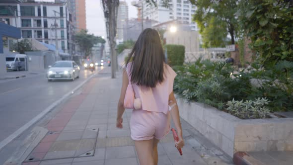 The Girl is Walking on the Road in Anger and the Camera is Following Her From Behind alt