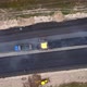 Drone move down to the yellow road paver and workers. Roadworks on the motorway - VideoHive Item for Sale