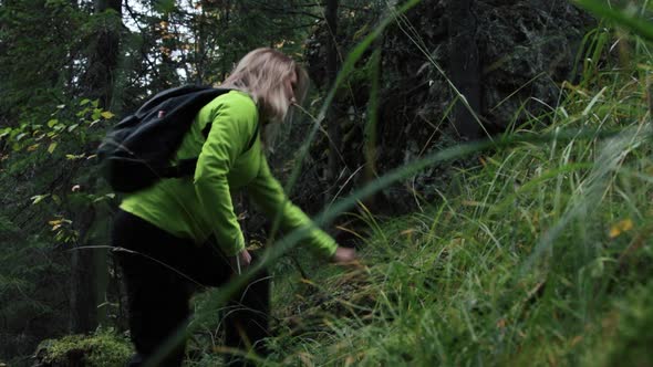 Woman tourist climbing up a hill