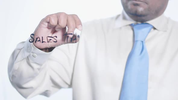 Asian Businessman Writes Sales Tax