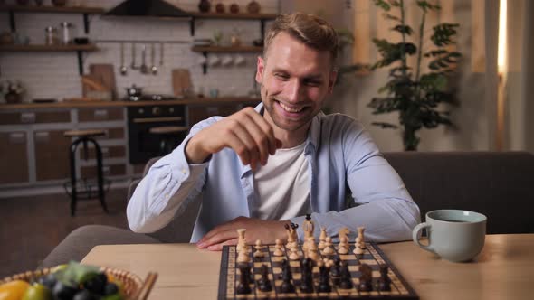 Young Man Playing Game of Chess Online with Friend alt