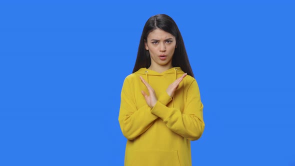Portrait of Brunette Strictly Gesturing with Hands Shape Meaning Denial Saying NO alt