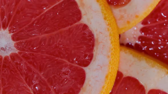 Colorful Fresh Citrus Fruit Slices of Grapefruit on Rotating Surface  Close Up