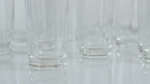 Transparent  spirits or liquor drink glass 4K 2160p 30fps UltraHD tilting footage - Close-up of shot