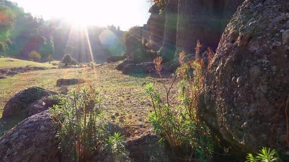Sunlit Mountain Valley Landscape and Rock Formations on a Summer Day alt