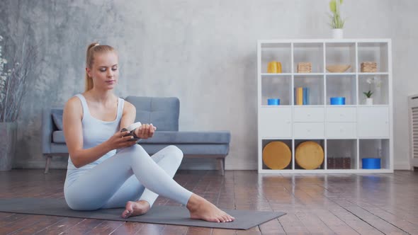 Young and sporty girl in sportswear is doing exercises at home. alt