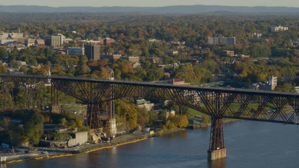 Aerial of walkway over Hudson river and town at a distance alt
