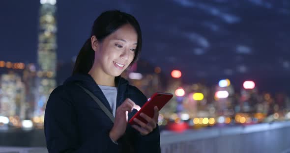 Woman Use of Mobile Phone in City at Night alt