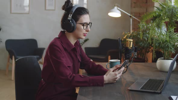 Woman Reading Speech Smartphone in Podcast Recording Studio alt