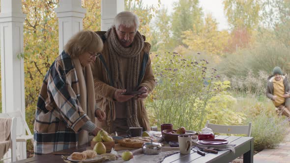 Boy Having Outdoor Lunch with Grandparents alt