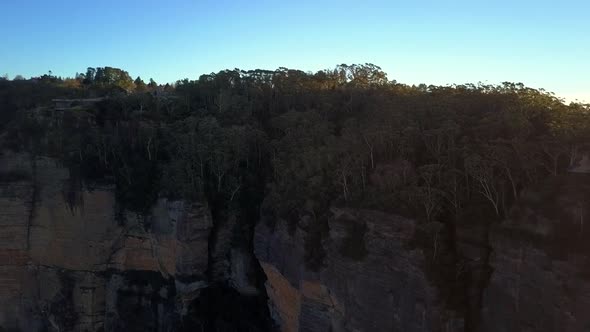 The Three Sisters rocks formation at Blue Mountains with view of clouds covering the rainforest tree alt